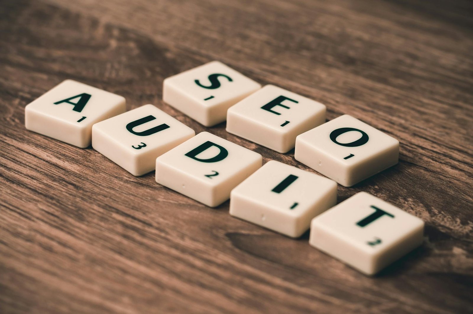 scrabble tiles spelling seo audit on wooden