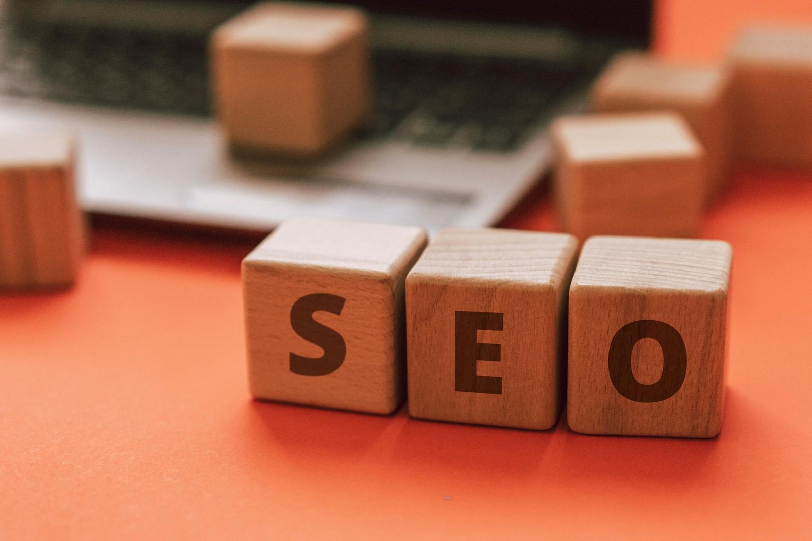 wooden blocks spelling seo on a laptop